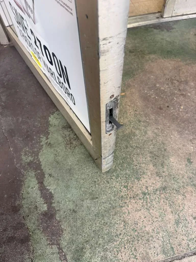 Commercial flush bolt replacement on a storefront door